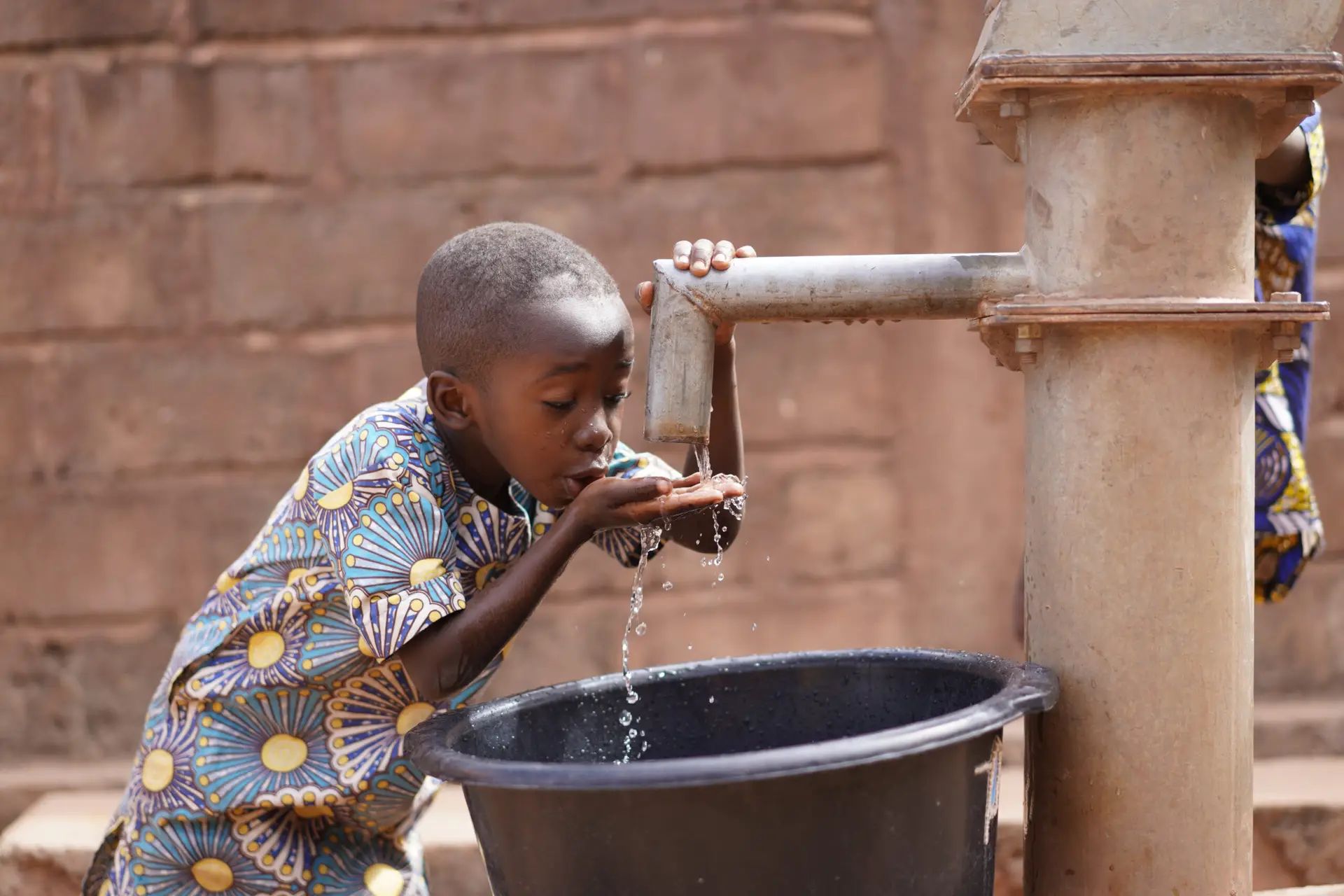 Young child accessing clean water in an African community